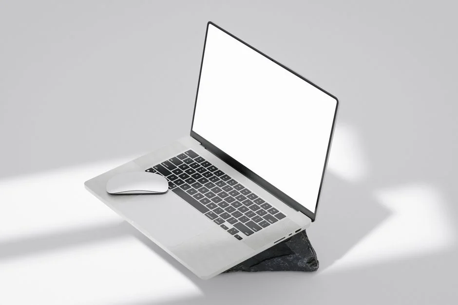 Close-up of a laptop and tablet on a wooden desk, showcasing modern technology.